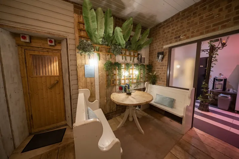 The relaxation area at The Workshop, with bench seating and the sauna door